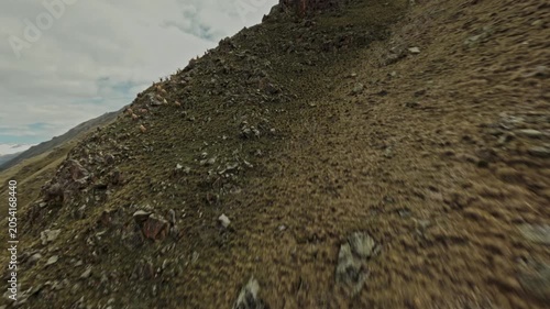The Fpv drone climbs up along the cliffs and notices a large herd of mountain goats. High quality 4k footage