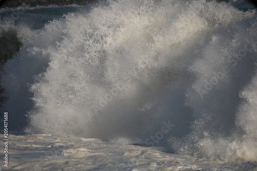 Giant shorebreak crashing on the sand at the wedge