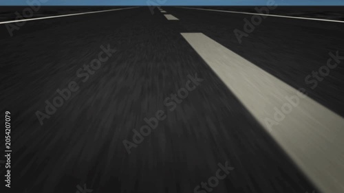 Low angle view of driving on an empty asphalt road with white dashed lines moving towards the horizon at speed