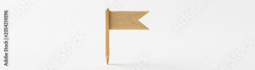 miniature blank toothpick flag pointed end placed upright center frame soft diffused studio lighting