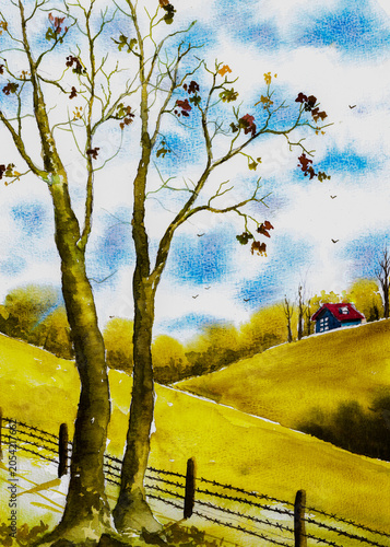 Watercolor autumn landscape with bare trees, golden rolling hills, blue sky and a small countryside house in nature.