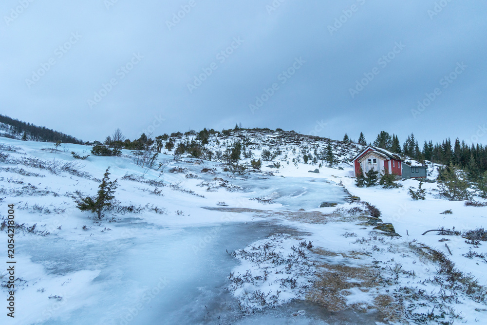 Fototapeta premium A beautiful misty mountain landscape with low clouds. A wintertime scenery in Geiranger Unesco World heritage area, Sunnmore, More og Romsdale, Norway.