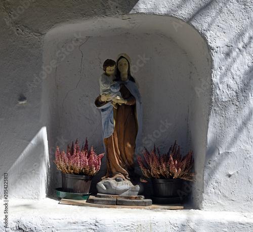 Tableau sur toile votive shrine, or sacred niche with a polychrome sculpture depicting the Madonna with Child in her arms, typical of a farm in val di funes South Tyrol  S