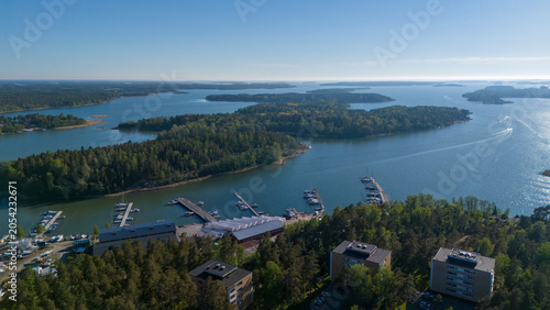 Aerial drone view of residential apartment buildings surrounded by pine forest and sea in Uusikaupunki