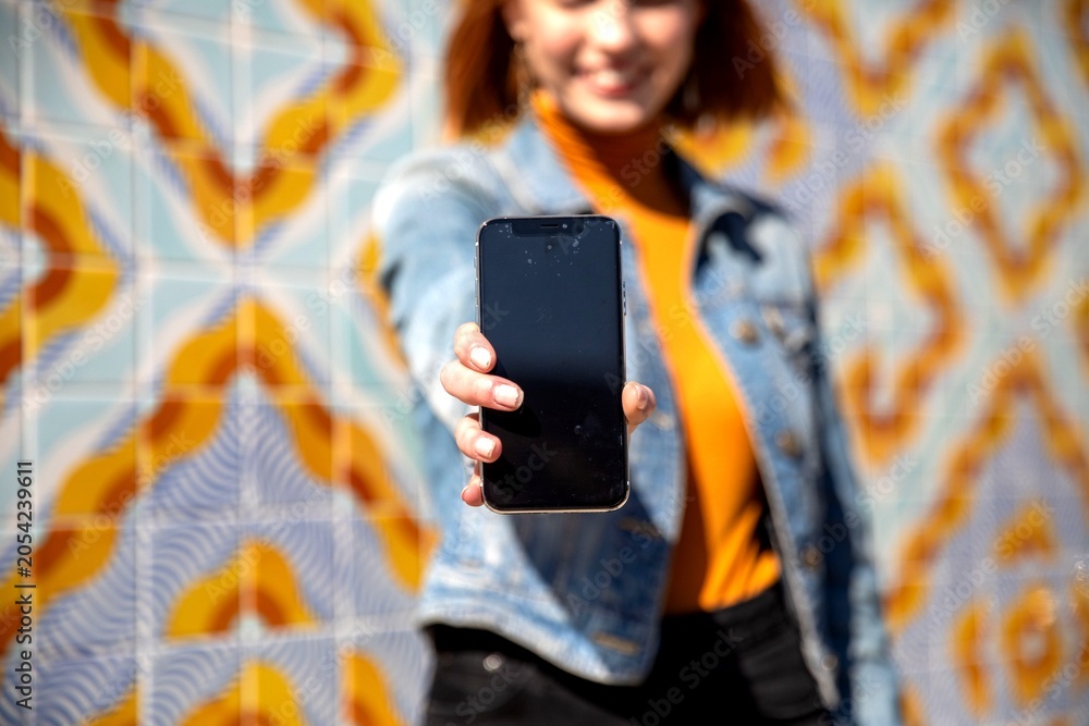 Fototapeta premium Smartphone focus with vibrant background.