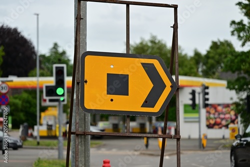 Photos Temporary yellow diversion sign with right arrow at busy intersection