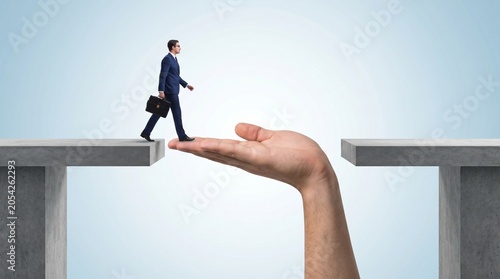 Tiny businessman walking across a giant helping hand bridging a gap isolated on transparent background for conceptual marketing graphics
