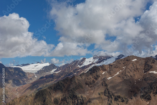 Awesome panorama of glaciers between Italy and Austria with Gepatschferner and Palla Bianca half hidden by the clouds visible. Mountains popular with hikers and climbers. Vallelunga, Alto Adige, Italy