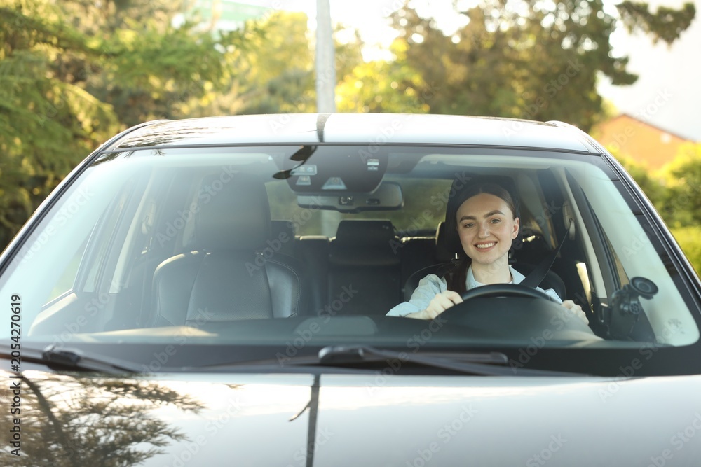 Fototapeta premium Woman driving modern car, view through windshield