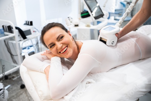 Happy woman enjoying a beauty treatment at a modern spa facility
