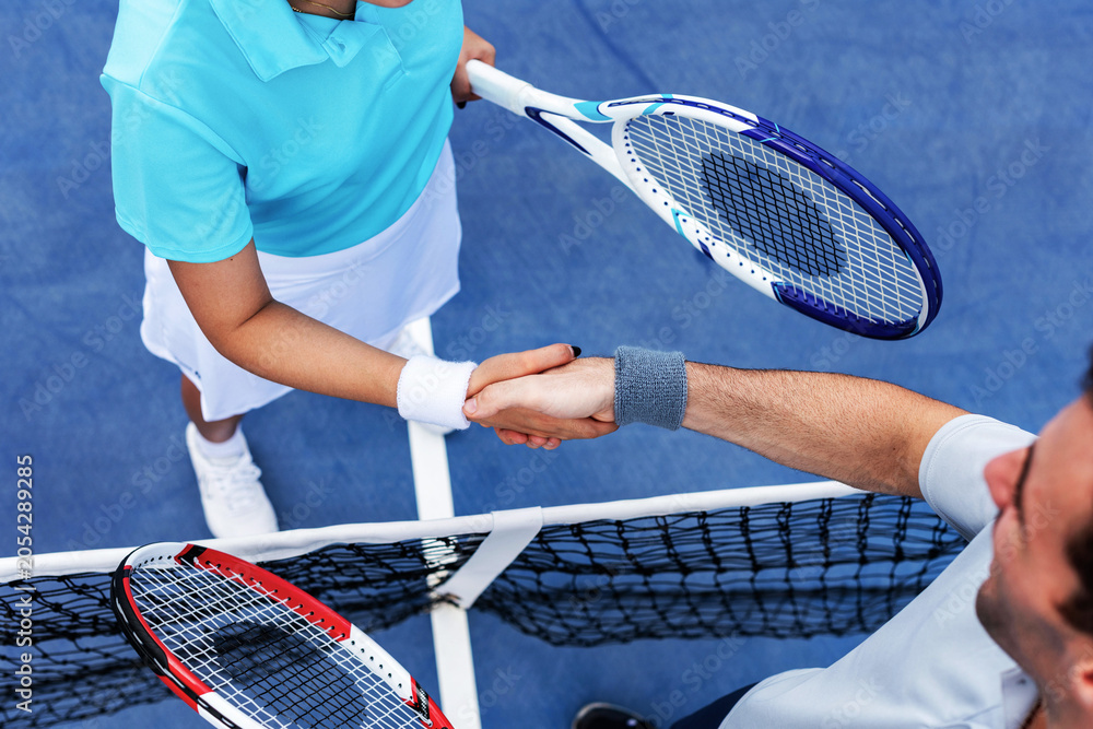 Obraz premium Tennis players handshake net photo