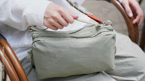 close up of a woman holding a bag, convenient and practical bag, city lifestyle, hiking