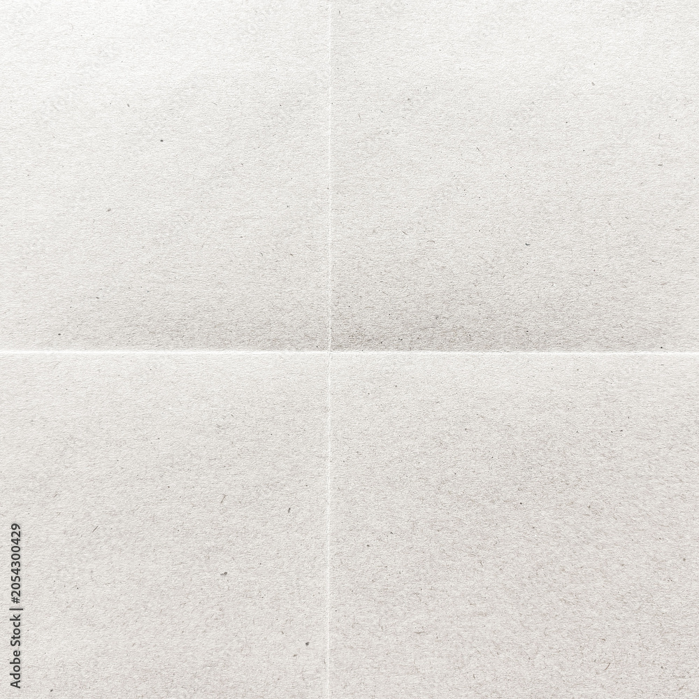 Fototapeta premium Close-up of a textured, blank white paper with subtle creases.