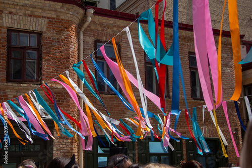 Colorful ribbons hanging outdoors for festive celebration in urban setting