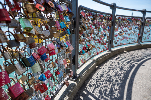 Colorful love locks on a seaside railing