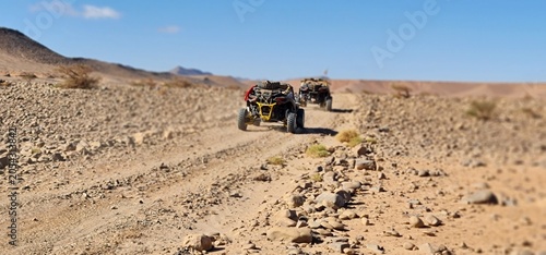 Quadro em tela Low Angle Tracking Shot of Dune Buggies on Rocky Desert Trail