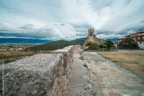 Stone Wall and Church Over Mountain Landscape in Frias, Spain