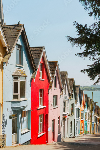 Iconic colorful homes in Cobh Ireland with St Colman's Cathedral