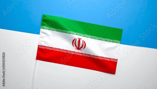 Iran national flag waving in clear sky, green white red stripes with central emblem and Kufic script, symbol of identity and cultural heritage…
