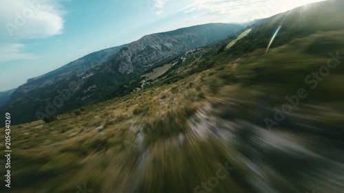 FPV Drone Shot Diving Fast Down Green Grass Mountain lope