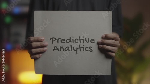 Predictive Analytics Written on Banner – Man Holding Placard