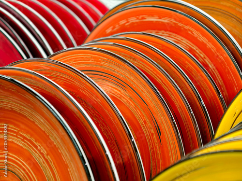 Photos Close up of beautiful red and yellow ceramic plates on supermarket shelves, luxu