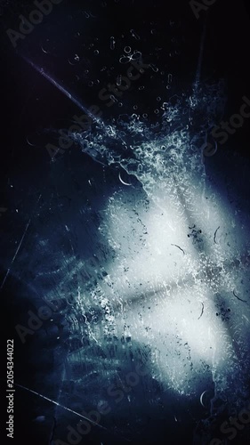 Abstract dark background with light streaks and glowing particles.