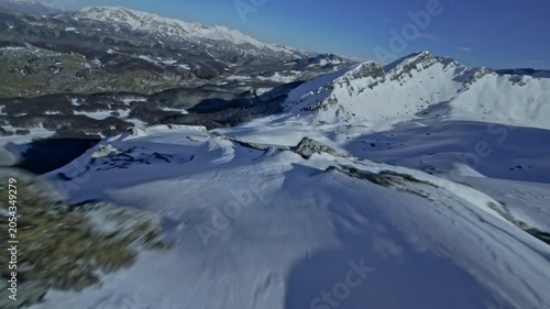 FPV Drone Shot Sweeping Close Over Snowy Mountain Sloe crest