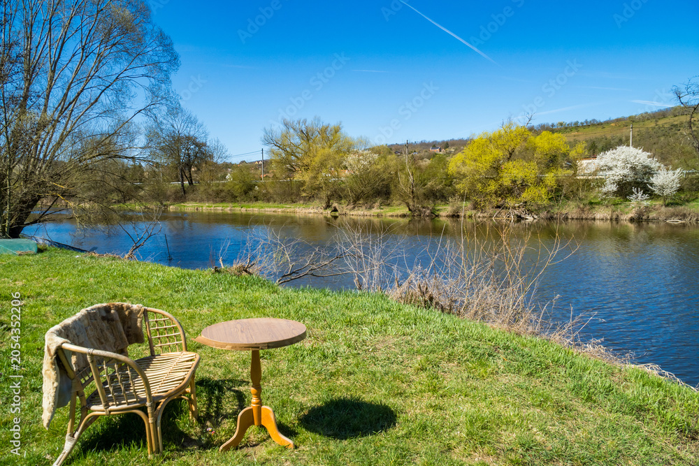 Fototapeta premium Modern design of garden furniture stands by the river, for relaxation. Czech
