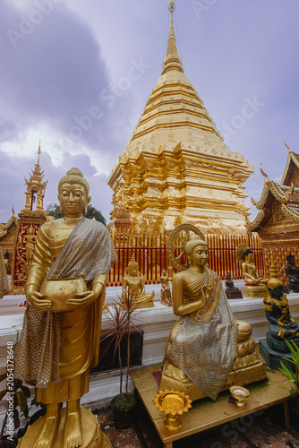 Photography Golden Buddha statues stand before the Wat Phra That Doi Suthep temple in Chiang Mai, Thailand
