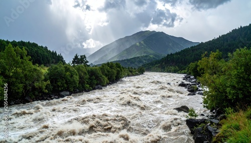 A powerful river with turbulent rapids flows through a lush mountain valley under a dramatic, stormy sky