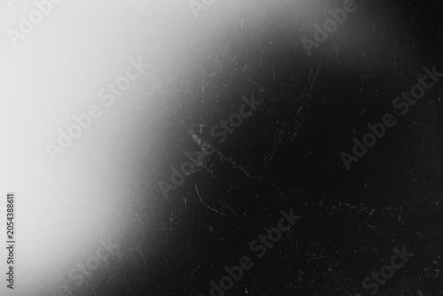 Black and White Film Grain Texture with Soft Light Gradient and Scratch Overlay