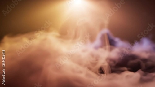 Dramatic glowing light illuminating abstract smoke and fog