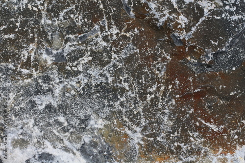 Cuadro en lienzo Close-up texture of a dark, weathered rock with white mineral deposits