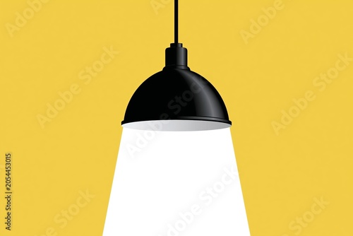 Black pendant lamp with bright light on yellow background