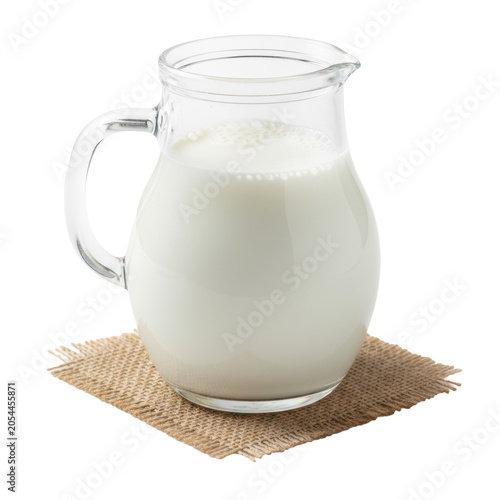 A meticulously detailed clear glass pitcher filled with creamy ultra-white milk and foam, on rustic brown jute fabric against a bright white studio background with copy space, high-key lighting,