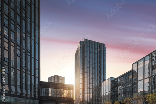 Schilderij op canvas Modern Glass Office Towers at Sunset in Urban Business District