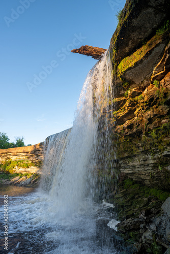 Scenic waterfall in the sunset light. Jagala Waterfall.