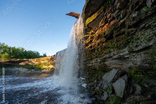 Scenic waterfall in the sunset light. Jagala Waterfall.