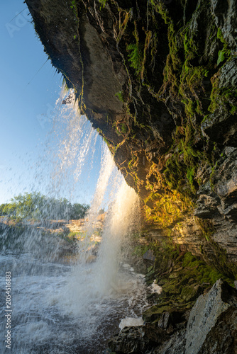 Scenic waterfall closeup in the sunset rays. Jagala Waterfall.