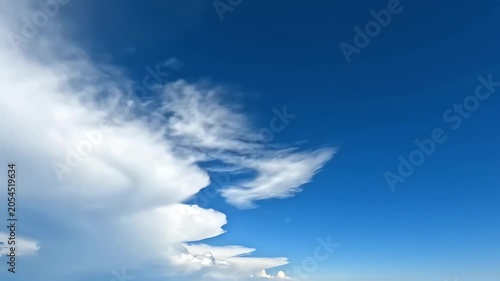 Clear blue sky with white clouds on a bright day, providing a peaceful and serene natural backdrop