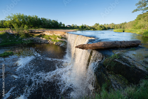 Scenic waterfall in the sunset light. Jagala Waterfall.