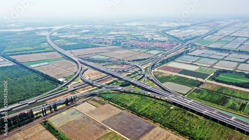 Εκτύπωση καμβά Aerial view of expressway overpass interchange above farmland and ponds