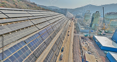 Bilde på lerret Aerial view of hillside solar power plant and industrial construction site