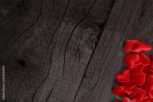 Red Hearts Scattered on Wooden Background Symbolizing Love and Passion