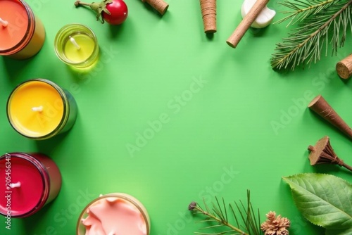 Assorted candle making materials flat lay on vibrant green , home fragrance, tools