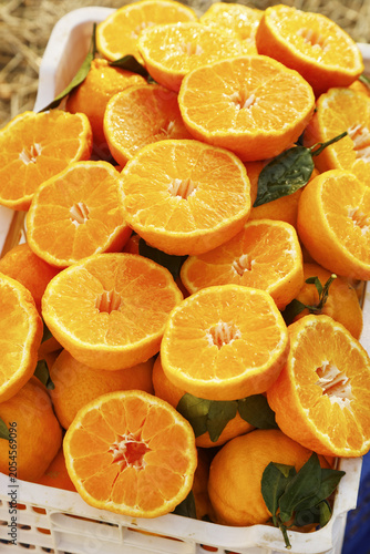 Canvas Print Fresh Cut Oranges in White Crate - Vibrant Citrus Fruit Display