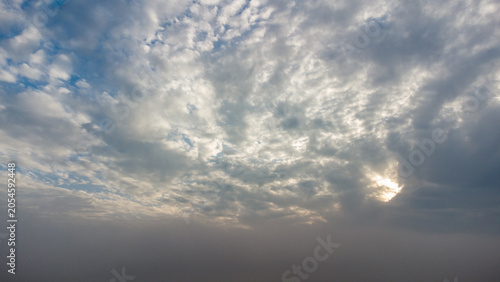 Stunning dramatic sky with sunlight breaking through clouds at golden hour
