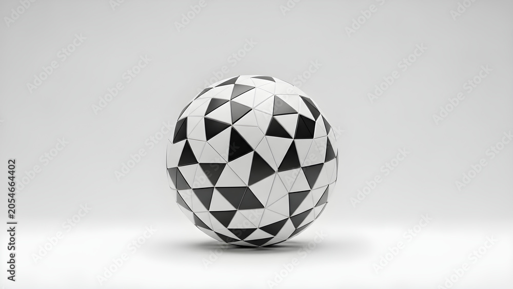 Fototapeta premium A geometric sphere with black and white triangular patterns sits on a plain surface