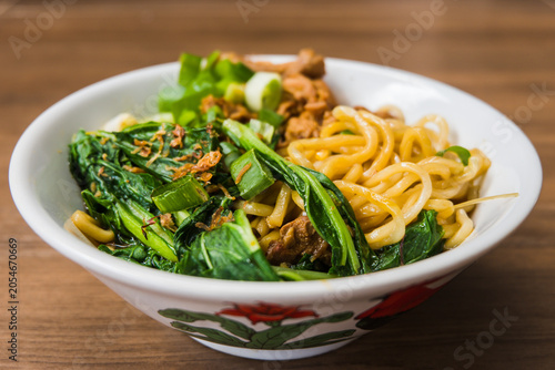 Side View of Indonesian Chicken Noodles with Green Vegetables
